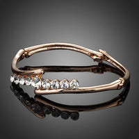 Close up detail of KHAISTA twist design crystal bangle