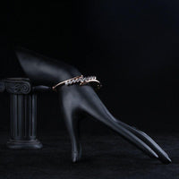 Side angle view of KHAISTA twist design crystal bangle