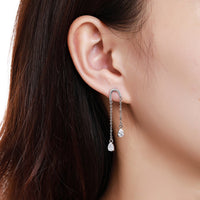 Close up of KHAISTA U-shape pear cut crystal earrings