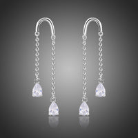 KHAISTA U-shape pear cut crystal earrings on white background