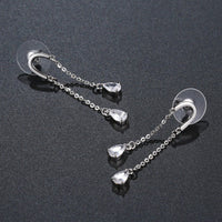 Side angle view of KHAISTA U-shape pear cut crystal earrings