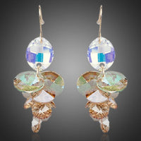 KHAISTA unique Stellux crystal drop earrings on white background
