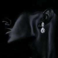 Side angle view of KHAISTA waterfall crystal drop earrings