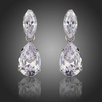 KHAISTA waterfall crystal drop earrings on white background