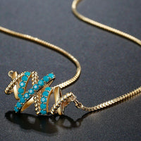 Pendant detail on KHAISTA vintage letter X pendant necklace
