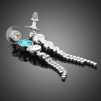 Side angle view of KHAISTA water drop CZ drop earrings
