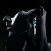 Close up of KHAISTA water drop CZ drop earrings