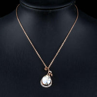 Side angle view of KHAISTA waterdrop peacock crystal pendant necklace