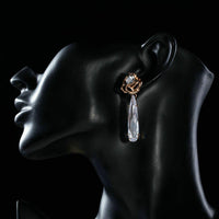 Side angle view of KHAISTA waterfall CZ drop earrings