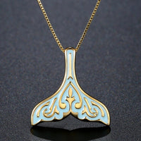 Side angle view of KHAISTA crystal whale fluke pendant necklace