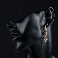 Side angle view of KHAISTA wheat design crystal drop earrings