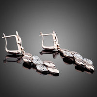Close up of KHAISTA wheat design crystal drop earrings