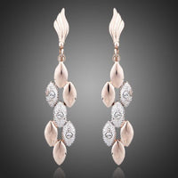 KHAISTA wheat design crystal drop earrings on white background
