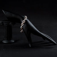 Side angle view of KHAISTA wheat design figaro chain bracelet