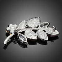 Close-up of white and pink crystals on Khaista leaf brooch