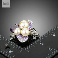 Close up of purple CZ and pearl on KHAISTA flower brooch