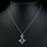 Close up detail of KHAISTA white gold bow knot long chain necklace