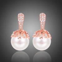 KHAISTA white pearl stud earrings on white background