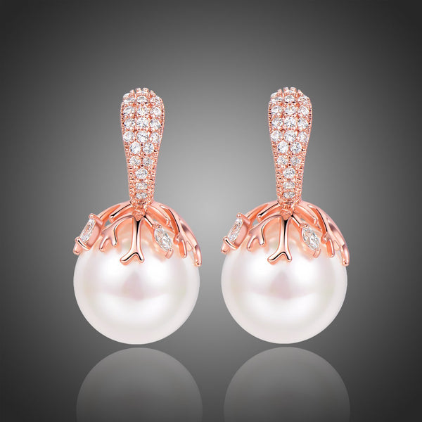 KHAISTA white pearl stud earrings on white background