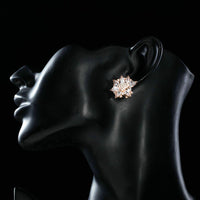 Side angle view of KHAISTA white rose CZ stud earrings
