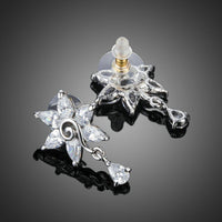 Close up of KHAISTA white rose CZ waterdrop earrings