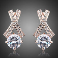 KHAISTA X charm crystal stud earrings on white background