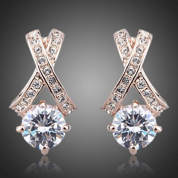 KHAISTA X charm crystal stud earrings on white background