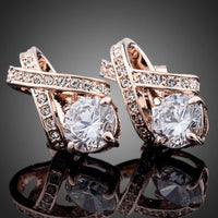 Close up of KHAISTA X charm crystal stud earrings